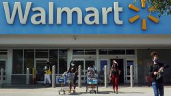 HALLANDALE BEACH, FLORIDA - MAY 18: People wearing protective masks walk from a Walmart store on May 18, 2021 in Hallandale Beach, Florida. Walmart announced that customers who are fully vaccinated against Covid-19 will not need to wear a mask in its stores, unless one is required by state or local laws. The announcement came after the Centers for Disease Control and Prevention said that fully vaccinated people do not need to wear a mask or stay 6 feet apart from others in most cases, whether indoors or outdoors. (Photo by Joe Raedle/Getty Images)