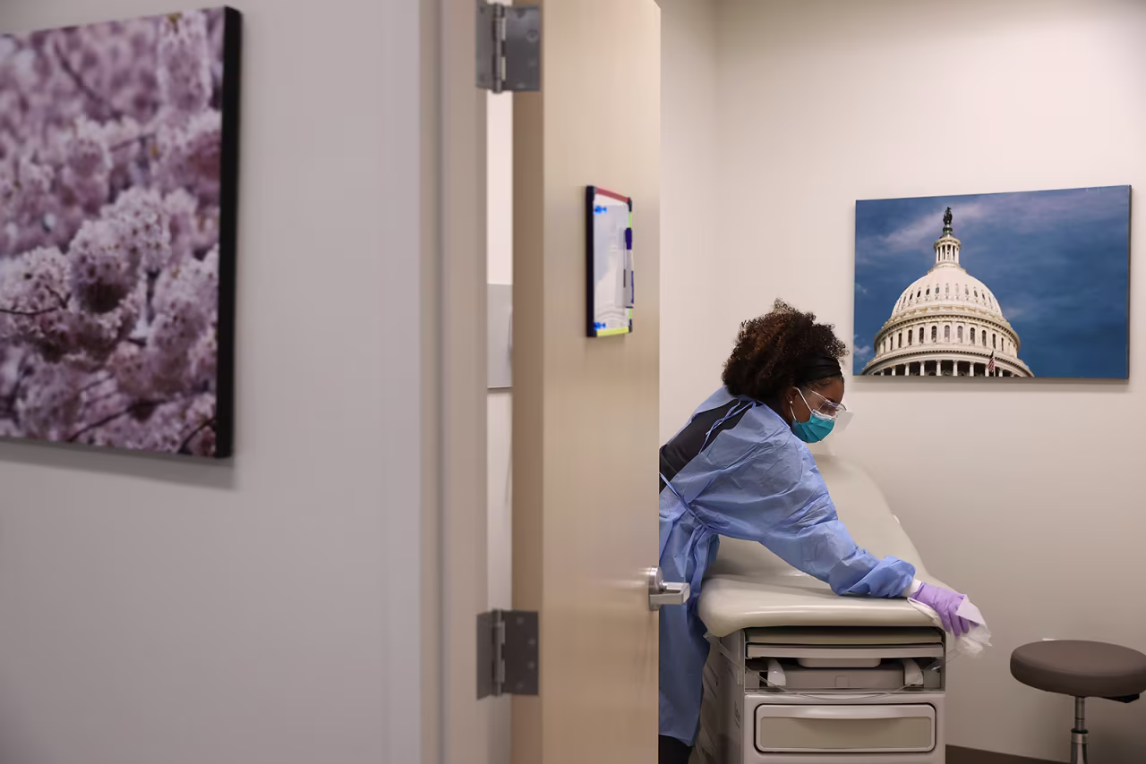 An urgent care X-ray technician and medical assistant disinfects an examination room in between testing patients for the novel coronavirus in Woodbridge, Virginia, on April 15. 